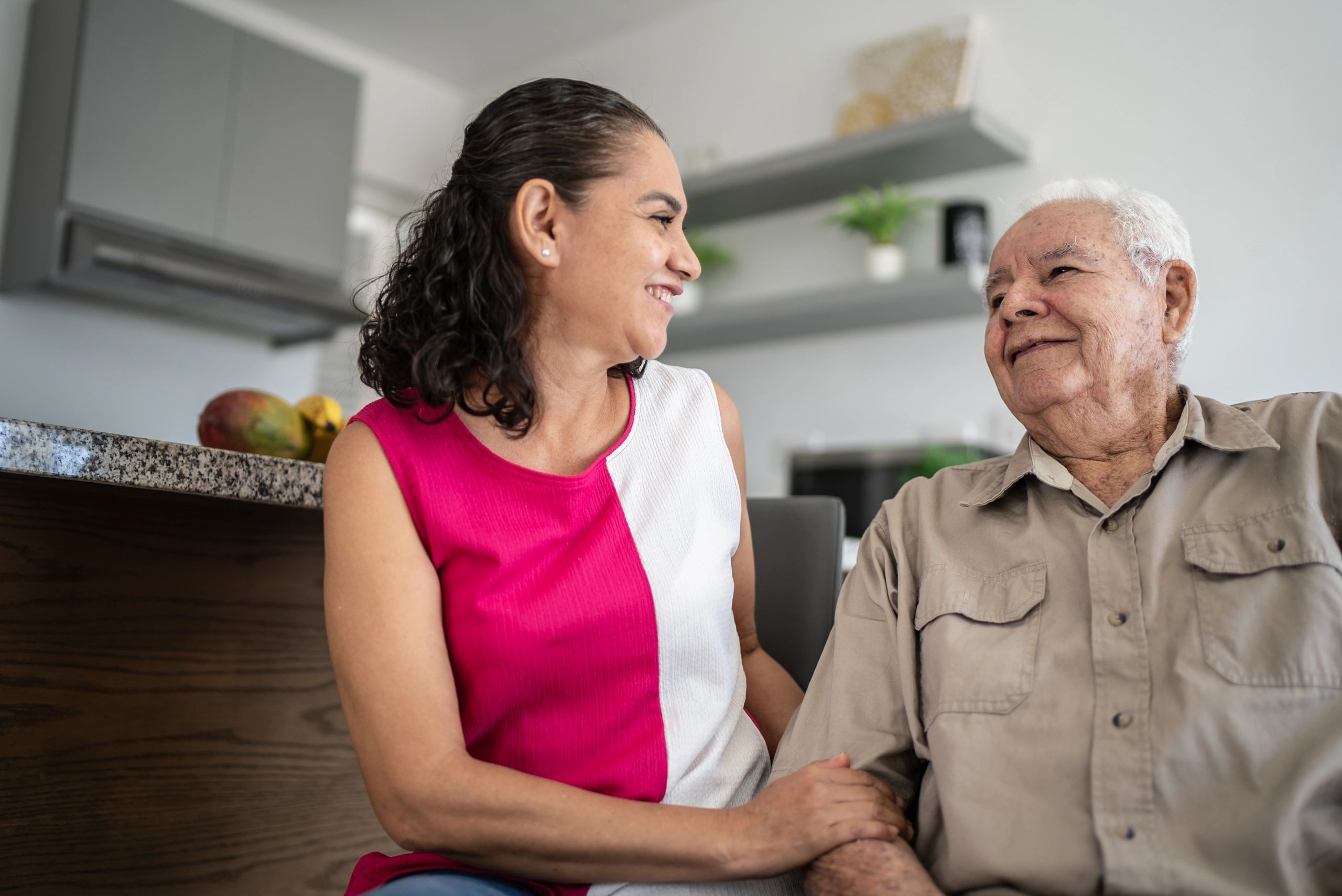 Senior man and his daughter talking at home