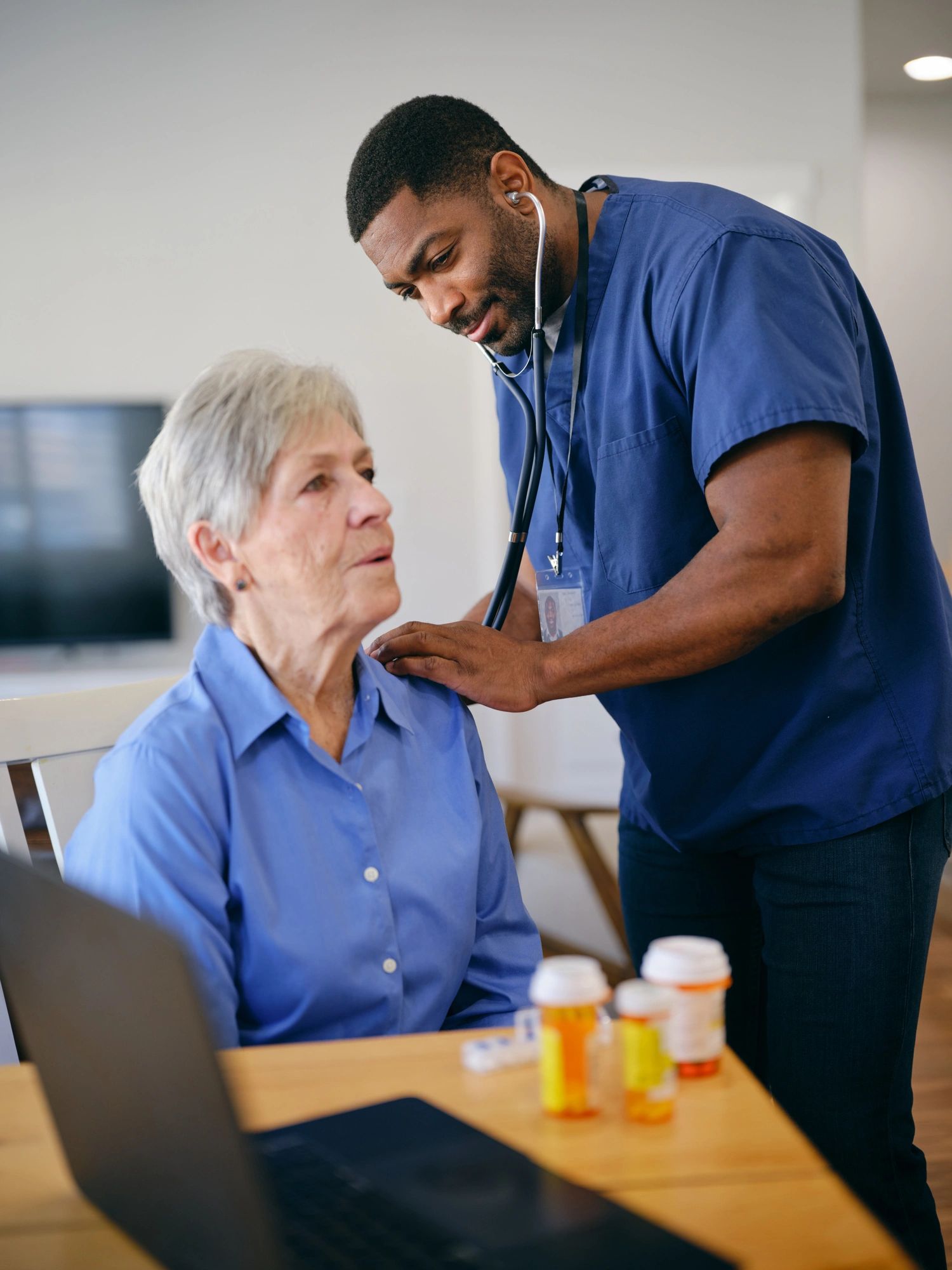 Home health provider supporting a senior woman at home
